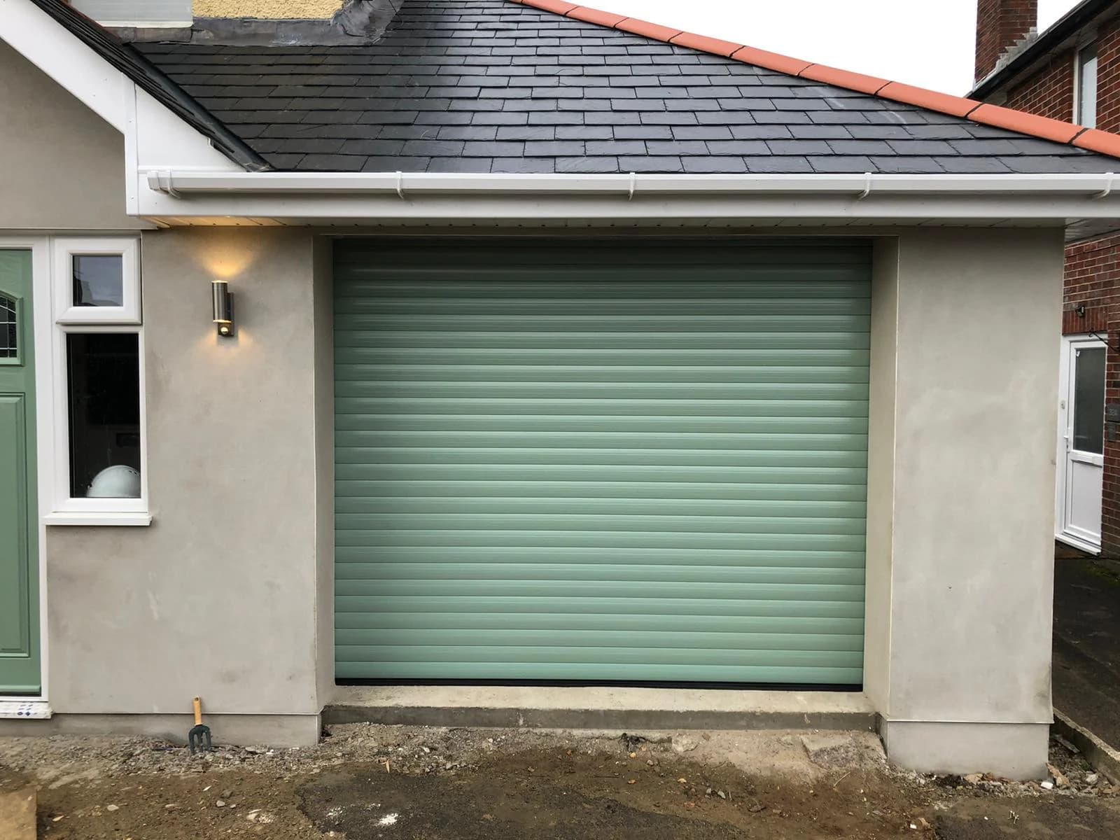 Chartwell green roller garage door installed on residential property